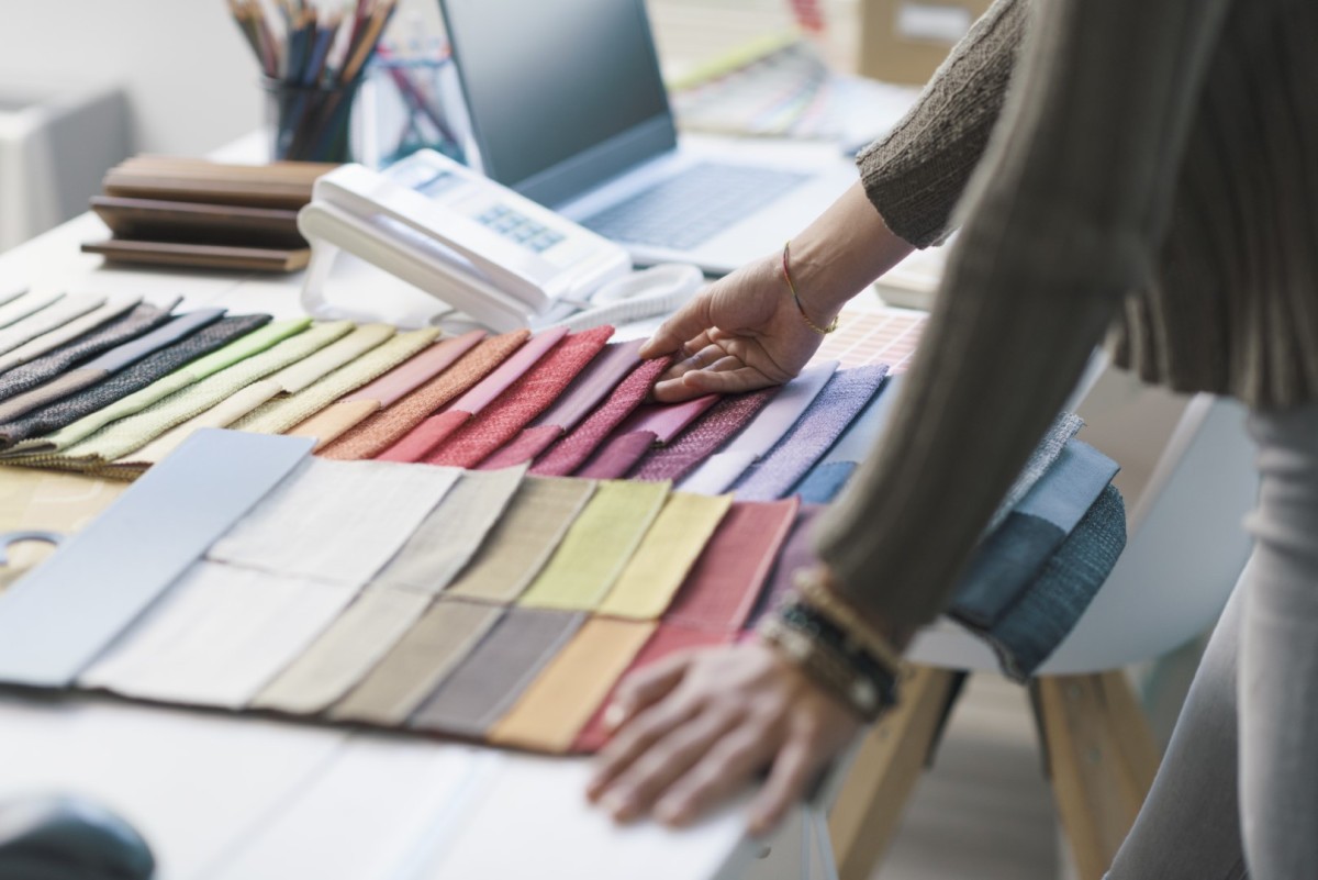professional-decorator-choosing-fabric-swatches-2023-11-27-04-54-38-utc