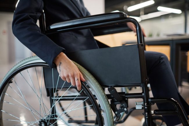 Businesswoman using Wheelchair Close Up