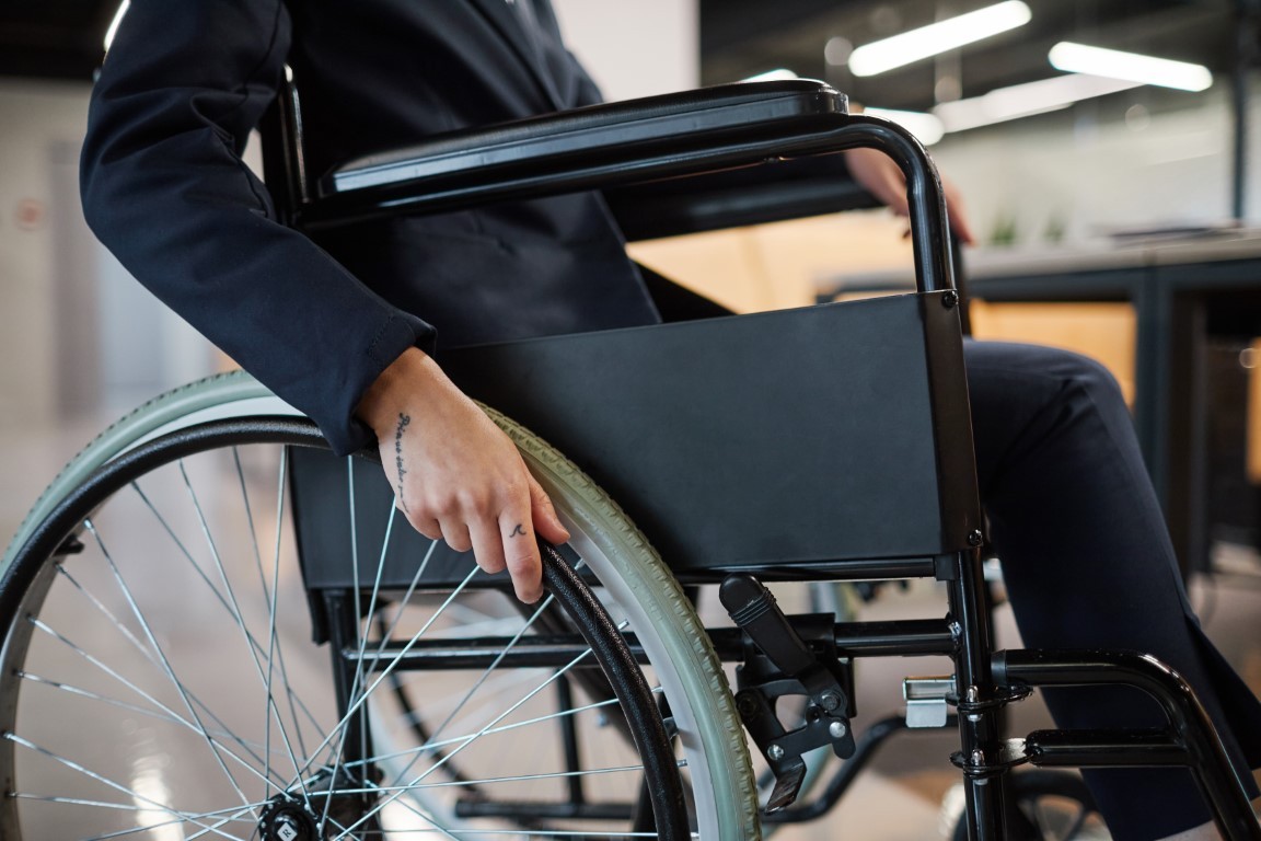 Businesswoman using Wheelchair Close Up