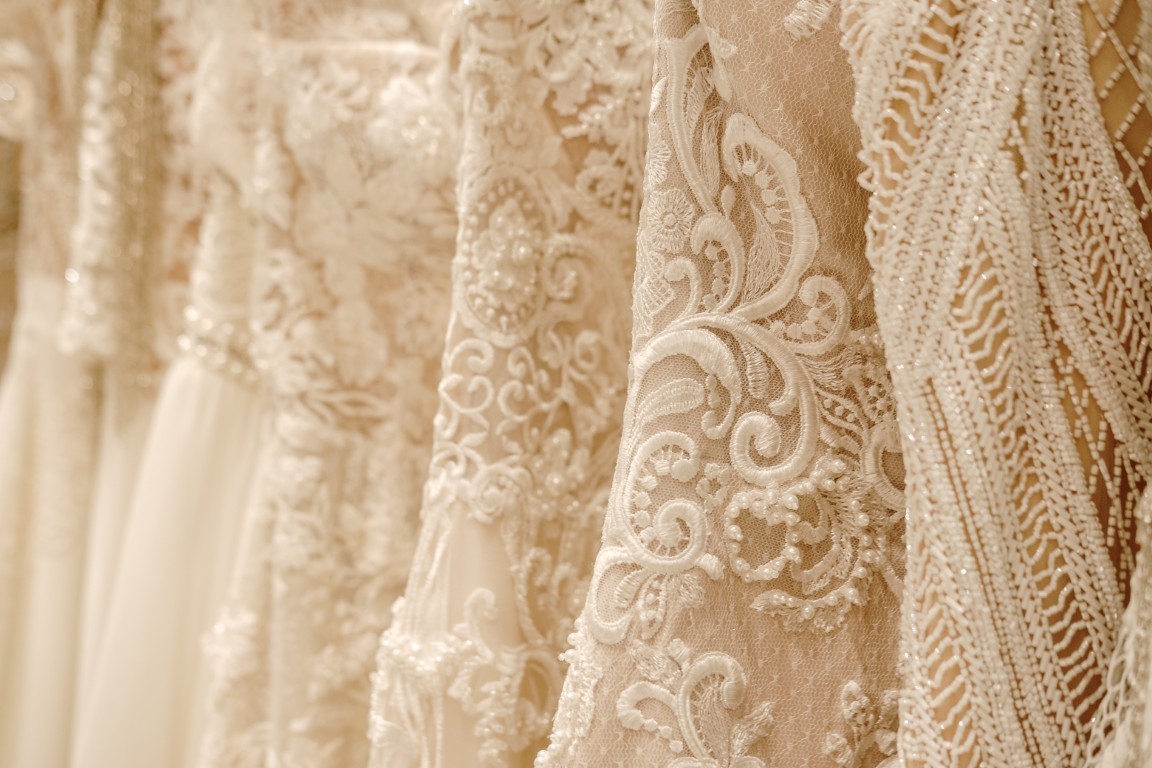 Cream wedding dresses hanging on the rack