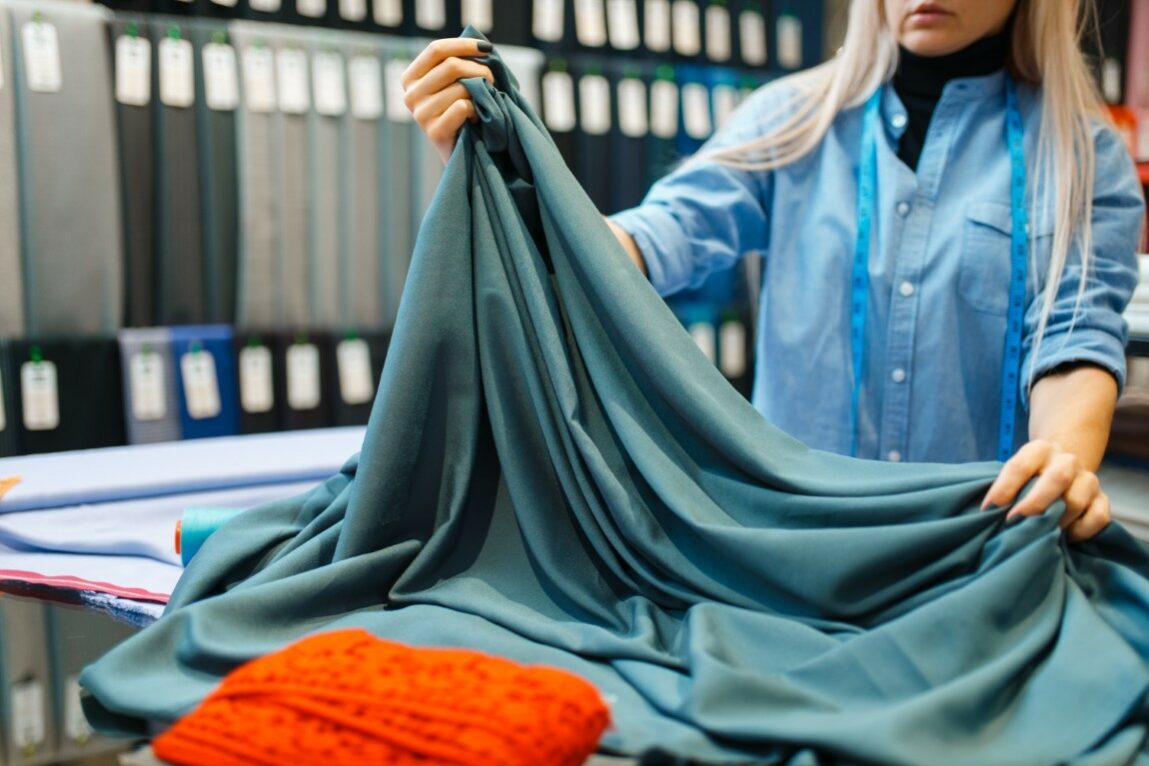 Seamstress works with fabric, textile workshop