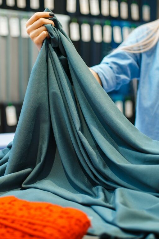 Seamstress works with fabric, textile workshop